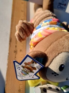 Musical Plush Sea Otter with Colorful Band